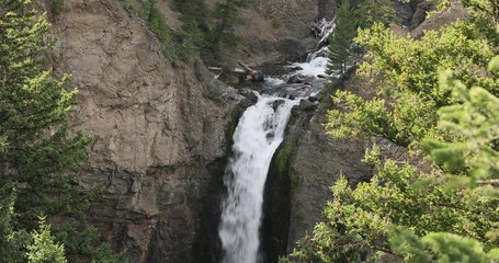 Yellowstone National Park river waterfall mountain. National Park in Wyoming. Geothermal ecosystem environment. Biology geography and ecology. Millions of tourist and visitors each year.