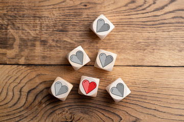 wooden blocks with heart icons on wooden background