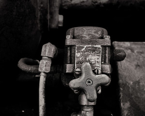 Stainless steel knob and hoses on the brakes on an abandoned railway car