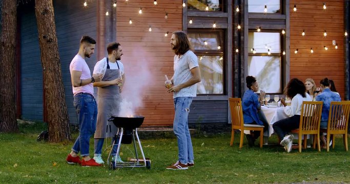 Large diverse group of friends people enjoying backyard barbecue party together, summertime outdoors lifestyle. 4K UHD
