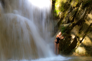 Woman with black bikini and waterfall