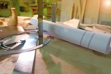 Old woodworking hand tools: wooden plane, chisel and carpentry workshop on a table covered with sawdust, side view