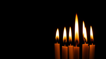 Blurred candles light on black background.