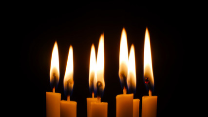 Blurred candles light on black background.