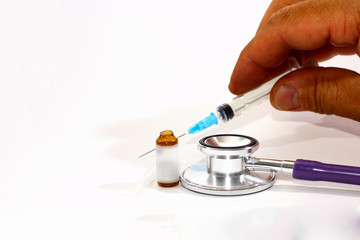 the doctor’s hand holds a syringe, an open ampoule , as a concept for providing medical care