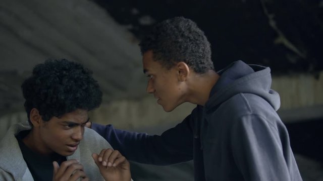 Black student bullying frightened male teenager, communication conflict, abuse
