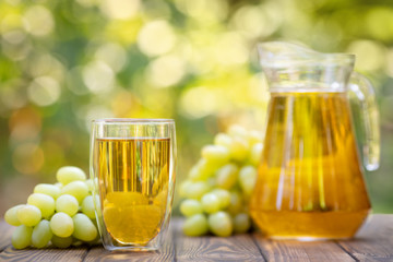 grape juice in glass and jug