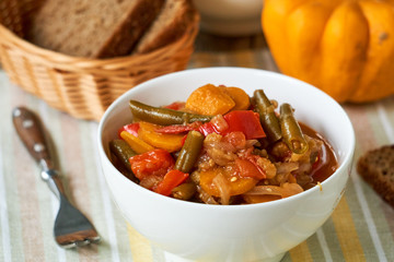 Vegetable ragout with green beans in a white bowl