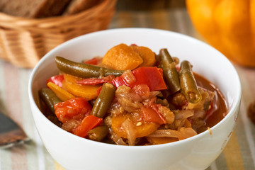Vegetable ragout with green beans in a white bowl