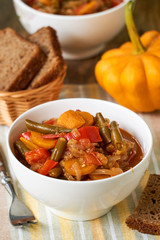 Vegetable ragout with green beans in a white bowl