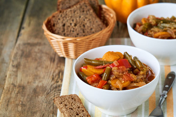 Vegetable ragout with green beans in a white bowl