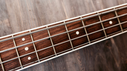 bass guitar neck . color background. closeup