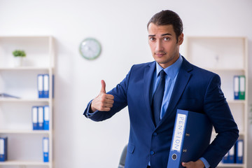 Young male accountant working in the office
