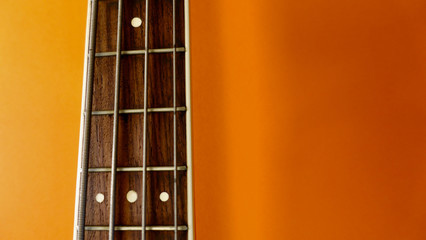 bass guitar neck . color background. closeup