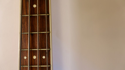 bass guitar neck . color background. closeup