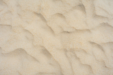 Beach sand texture in the summer sun.