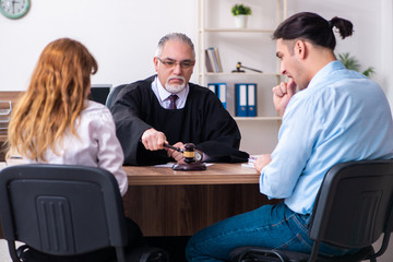 Young couple in the courthouse in divorce concept