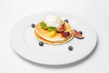 pancakes with ice cream and a berries
