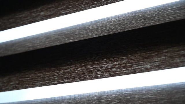 two fabric light filtering shade being opened
