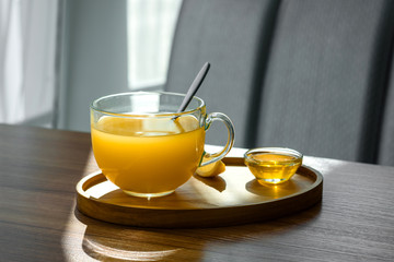 Hot winter tea from sea buckthorn. A cup of hot scented tea with sea buckthorn, honey and orange. Hot tonic drink in flu