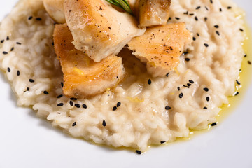 Delicious risotto with roasted pieces of chicken fillet. Risotto with chicken pieces. 