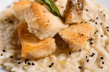 Delicious risotto with roasted pieces of chicken fillet. Risotto with chicken pieces. 