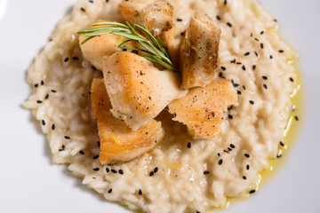 Delicious risotto with roasted pieces of chicken fillet. Risotto with chicken pieces. 