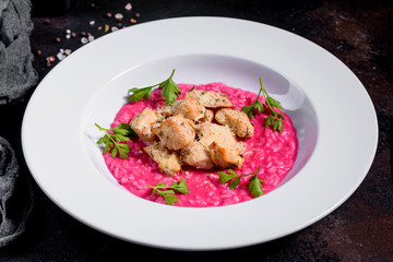 Delicious risotto with roasted pieces of chicken fillet. Risotto with chicken pieces. 
