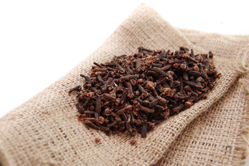cloves on burlap sacks isolated white background