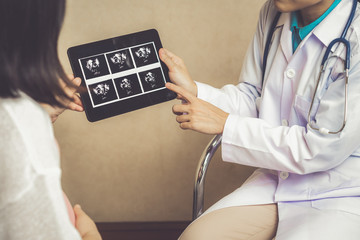 Happy pregnant woman visit gynecologist doctor at hospital or medical clinic for pregnancy...