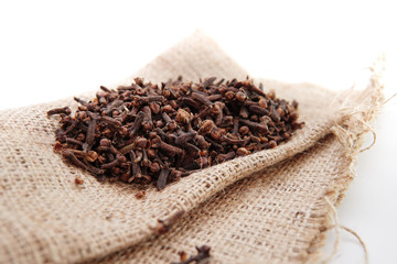 cloves on burlap sacks isolated white background