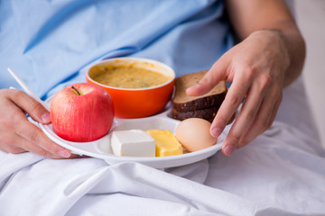 Male patient eating food in the hospital