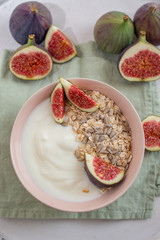 Oat granola with nuts, yogurt, honey, fresh figs and blueberries