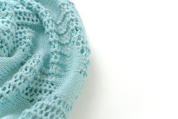 Aquamarine color crochet sweater on white background. Texture detail close up.