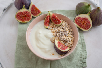 Oat granola with nuts, yogurt, honey, fresh figs and blueberries