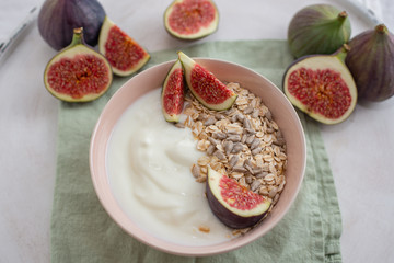 Oat granola with nuts, yogurt, honey, fresh figs and blueberries
