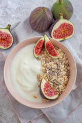 Oat granola with nuts, yogurt, honey, fresh figs and blueberries