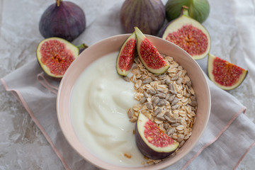 Oat granola with nuts, yogurt, honey, fresh figs and blueberries
