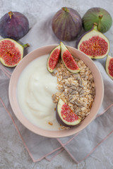 Oat granola with nuts, yogurt, honey, fresh figs and blueberries