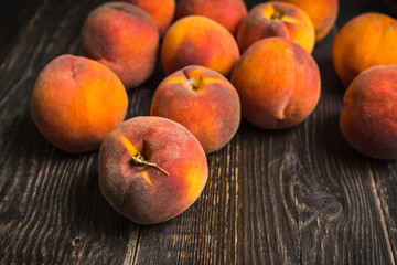 Sweet ripe peaches on the rustic background. Selective focus. Shallow depth of field.