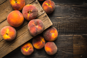 Sweet ripe peaches on the rustic background. Selective focus. Shallow depth of field.
