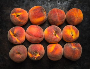 Fototapeta na wymiar Sweet ripe peaches on the rustic background. Selective focus. Shallow depth of field.