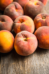 Sweet ripe peaches on the rustic background. Selective focus. Shallow depth of field.