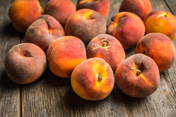 Sweet ripe peaches on the rustic background. Selective focus. Shallow depth of field.