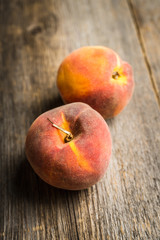 Sweet ripe peaches on the rustic background. Selective focus. Shallow depth of field.