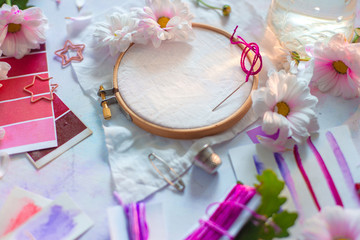 Embroidery frame header with flowers. Pink, white and purple pastel tones, copy space