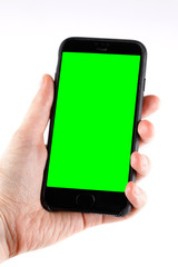 Touch screen smartphone in a hand.Man holding smartphone with blank screen on white background, closeup of hand. Space for text.