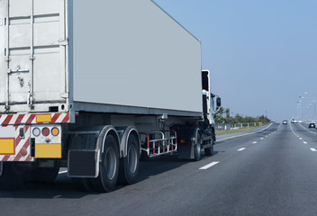 White Truck on highway road with container, transportation concept.,import,export logistic industrial Transporting Land transport on the asphalt expressway Against Sky 