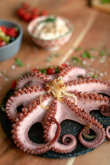 Grilled octopus gecorated with fresh herbs