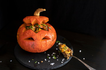 Baked Halloween pumpkin stuffed with lentil salad